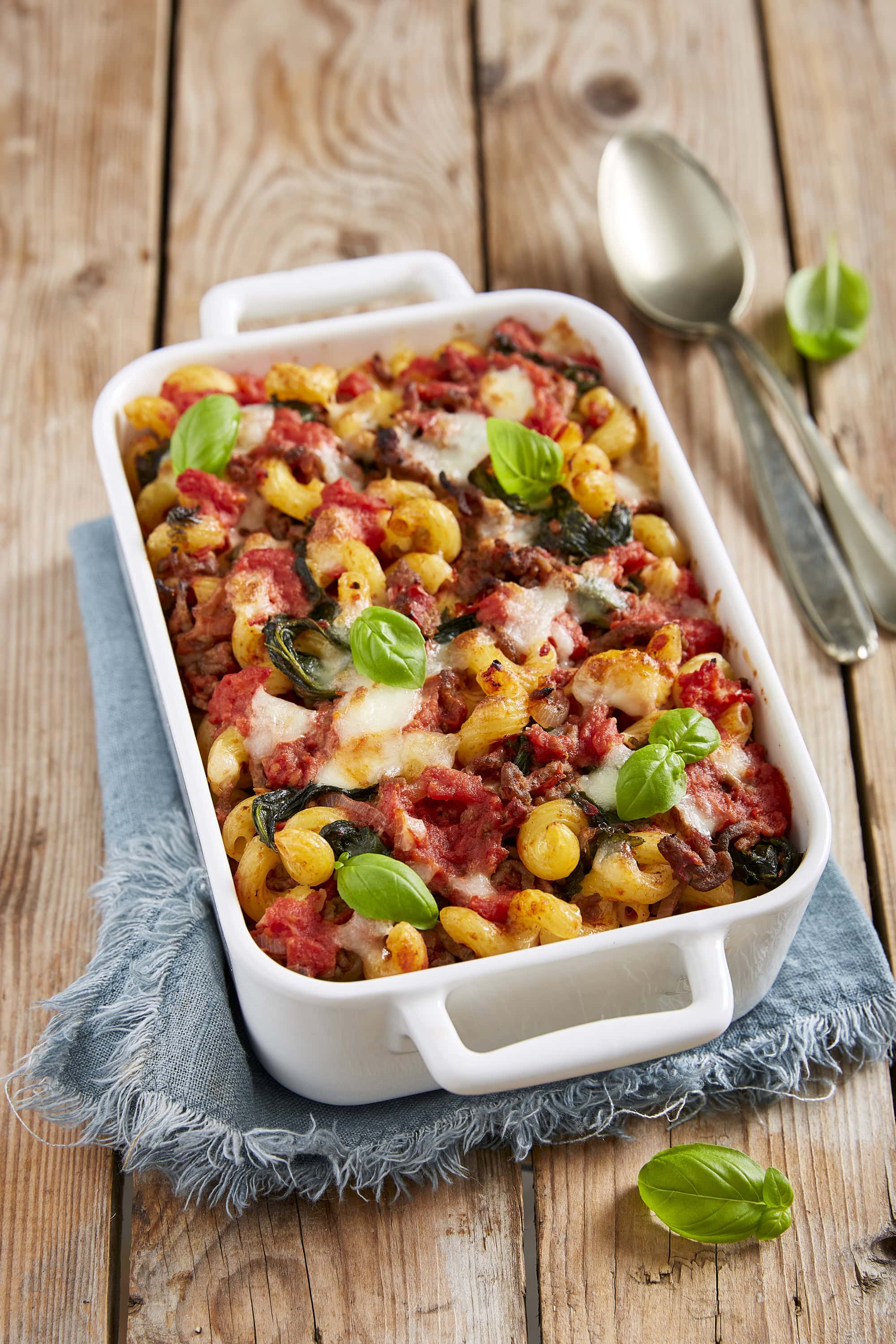 Macaroni casserole with minced meat, kale, mozzarella, polpa, basil